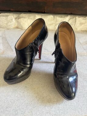Are you a shoe fixer upper? Christian Louboutin Black Patent Leather Zip Booties